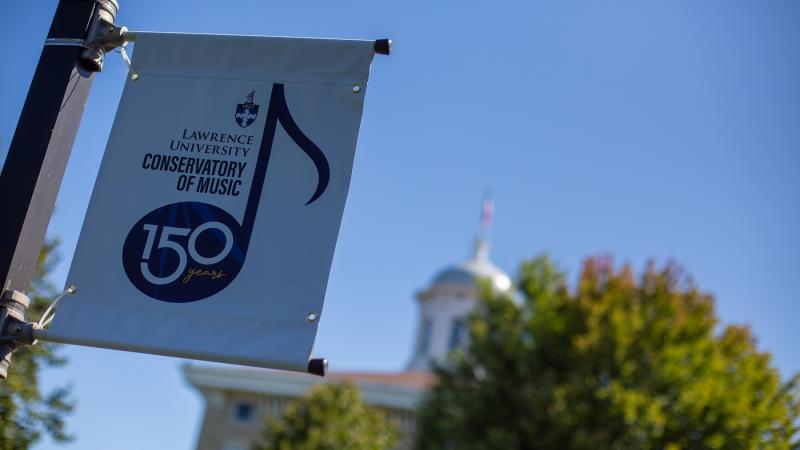 A 150 celebration banner hangs on a light pole on the Lawrence campus.