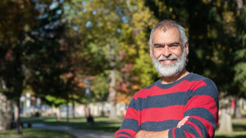 Andrew Knudsen poses for a portrait on Main Hall Green. 