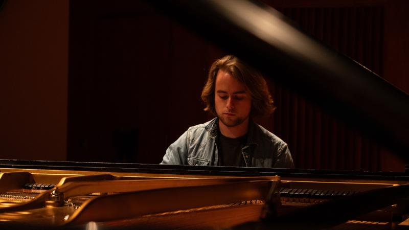 Benjamin Keating plays the piano. 