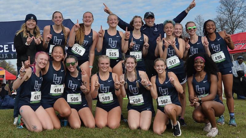 Women's cross country celebrates a conference title at Reid Golf Course.