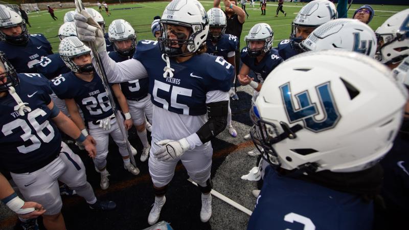 Vikings football players prepare to take the field at Banta Bowl.