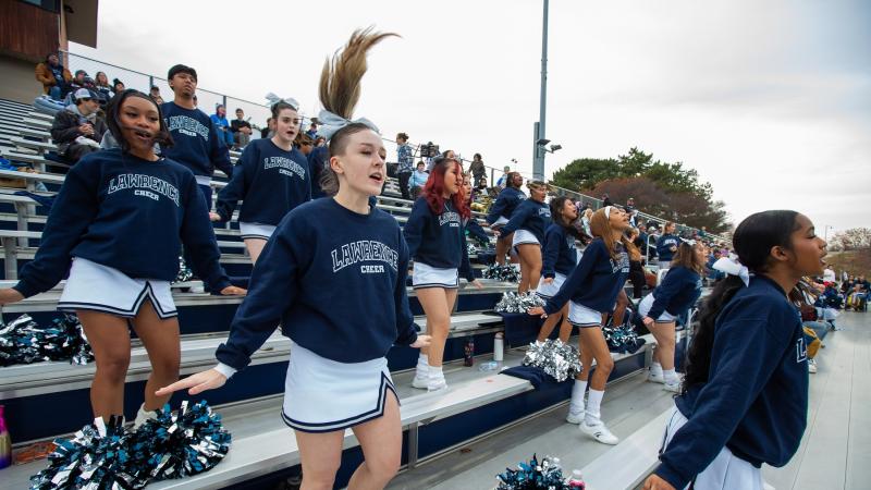 The cheer squad roots on the Vikings at the football game at Banta Bowl.