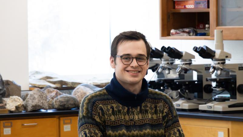 Zachary Hogan poses for a photo in a science lab at Lawrence University.