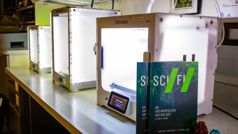 Sci Fi zines stand up against a 3D printer in the makerspace