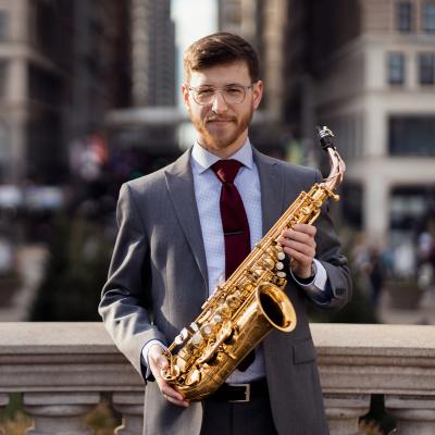 Joseph Connor formal headshot with saxophone