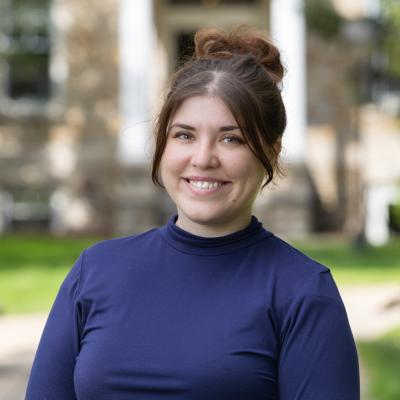 Woman in blue smiles at camera