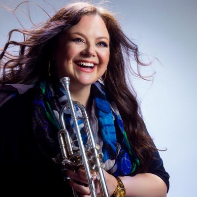 Nadje Noordhuis is laughing and holding a silver trumpet