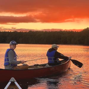 Two students canoeing at sunset - 2024 Land and Sea Pre-orientation Experience