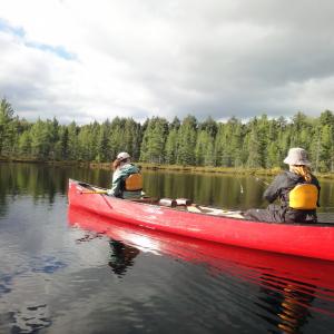 Students fishing in a canoe - 2024 Land and Sea Pre-orientation Experience